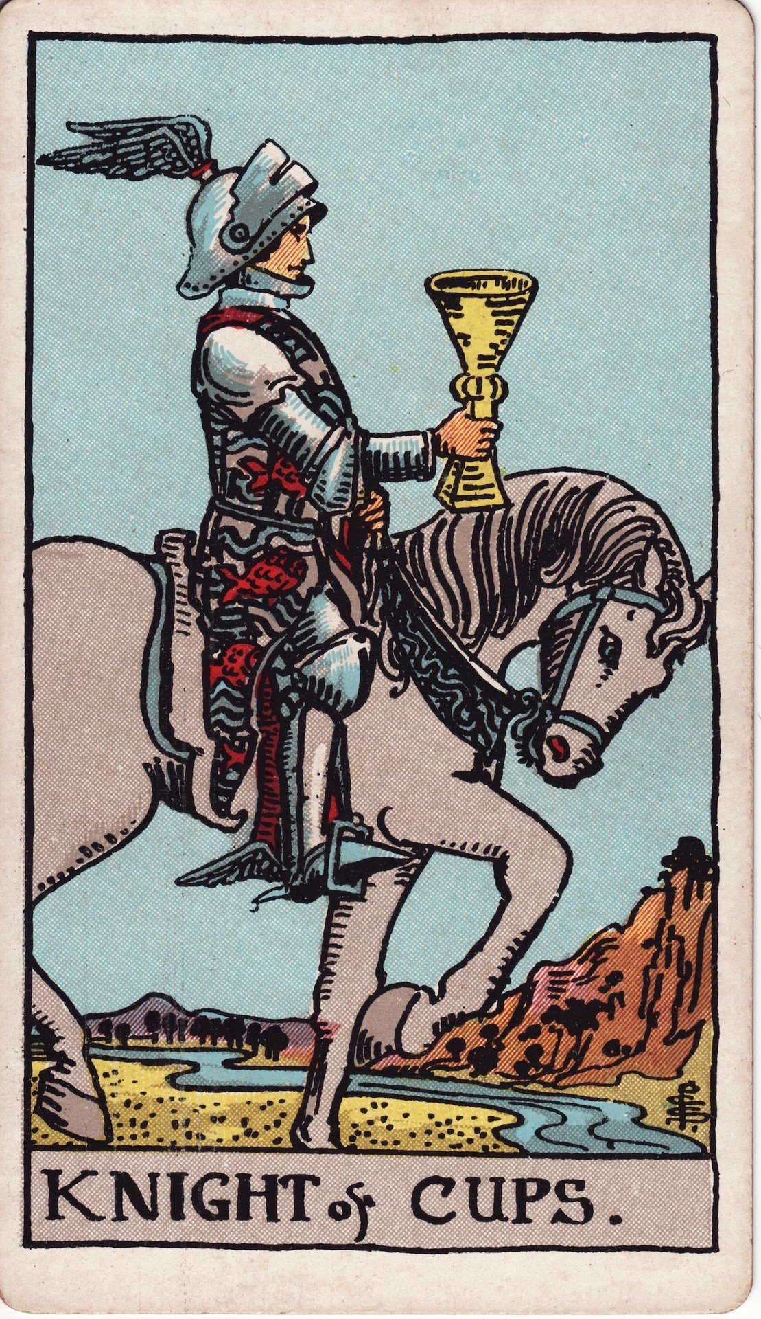 The Knight of Cups from the Rider-Waite-Smith tarot deck: a knight in winged helmet rides a white horse forward, holding a golden cup aloft, a river winding behind.