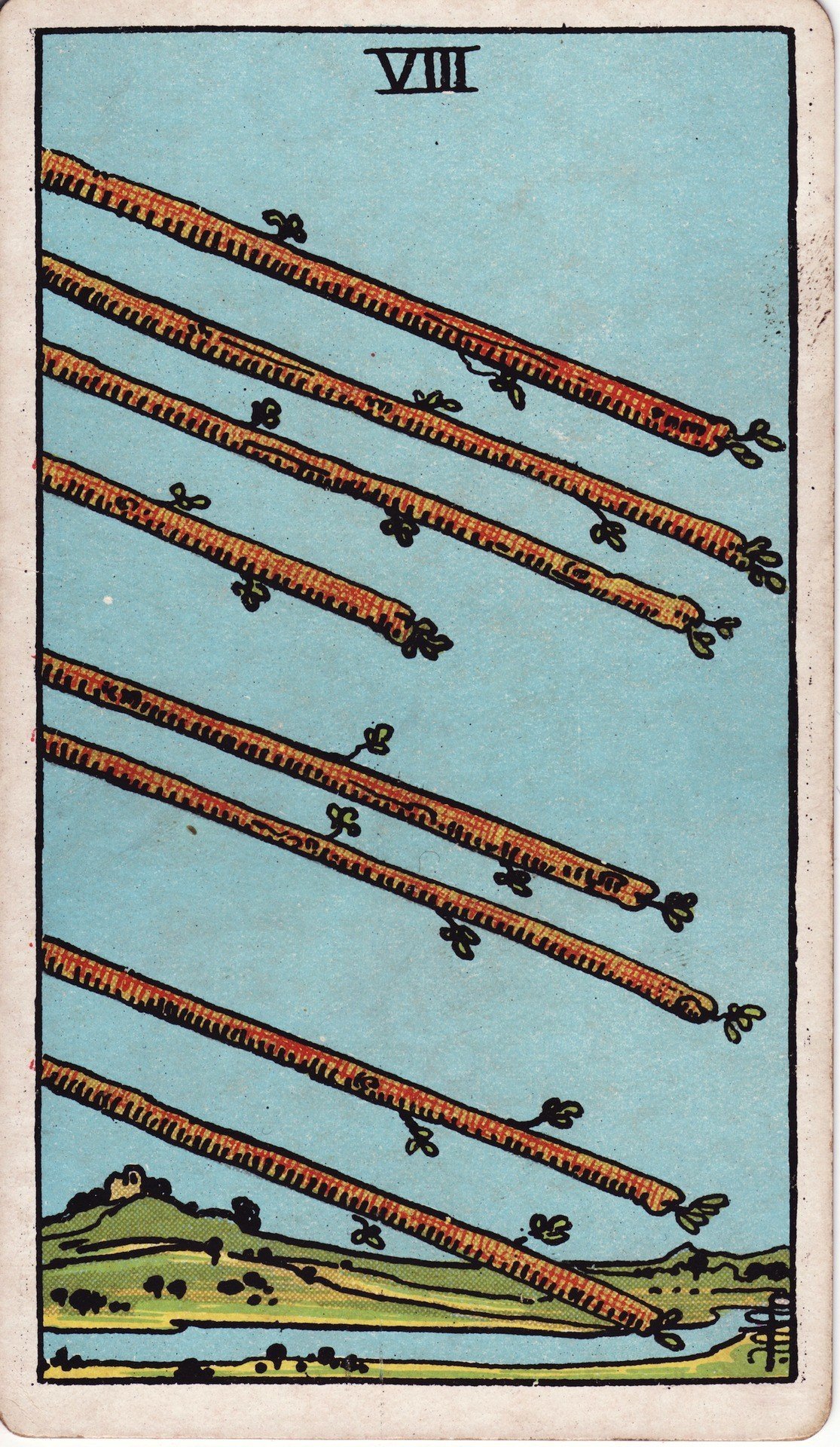 The Eight of Wands from the Rider-Waite-Smith tarot deck: eight wooden wands flying diagonally through a clear sky above a green landscape, all aligned in the same direction.