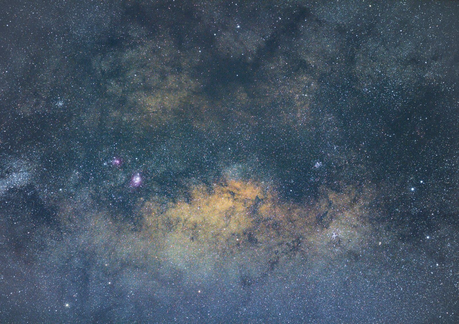 The Milky Way with dense star fields and golden dust clouds across a dark sky.