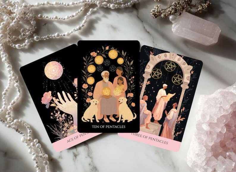 Three tarot cards on a marble surface surrounded by pearls and a crystal