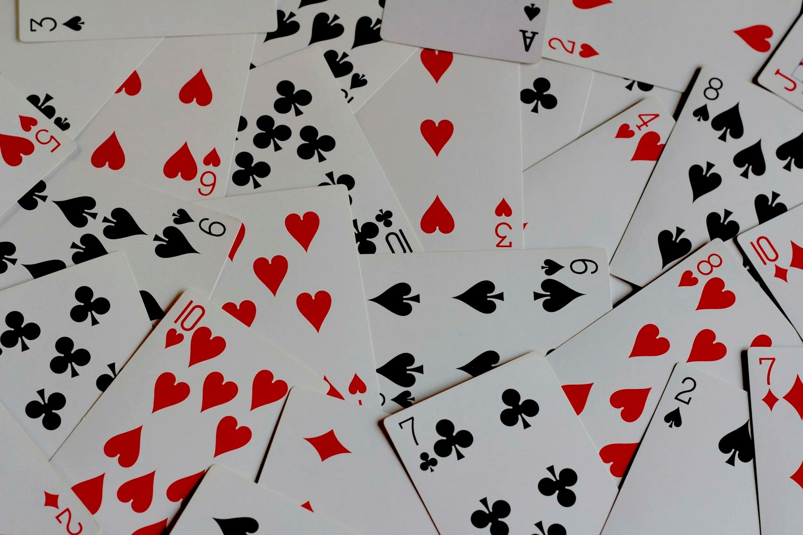 A photo of a deck of cards on a wooden surface.