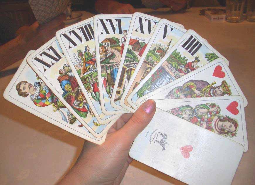 A hand fanning tarock cards face up
