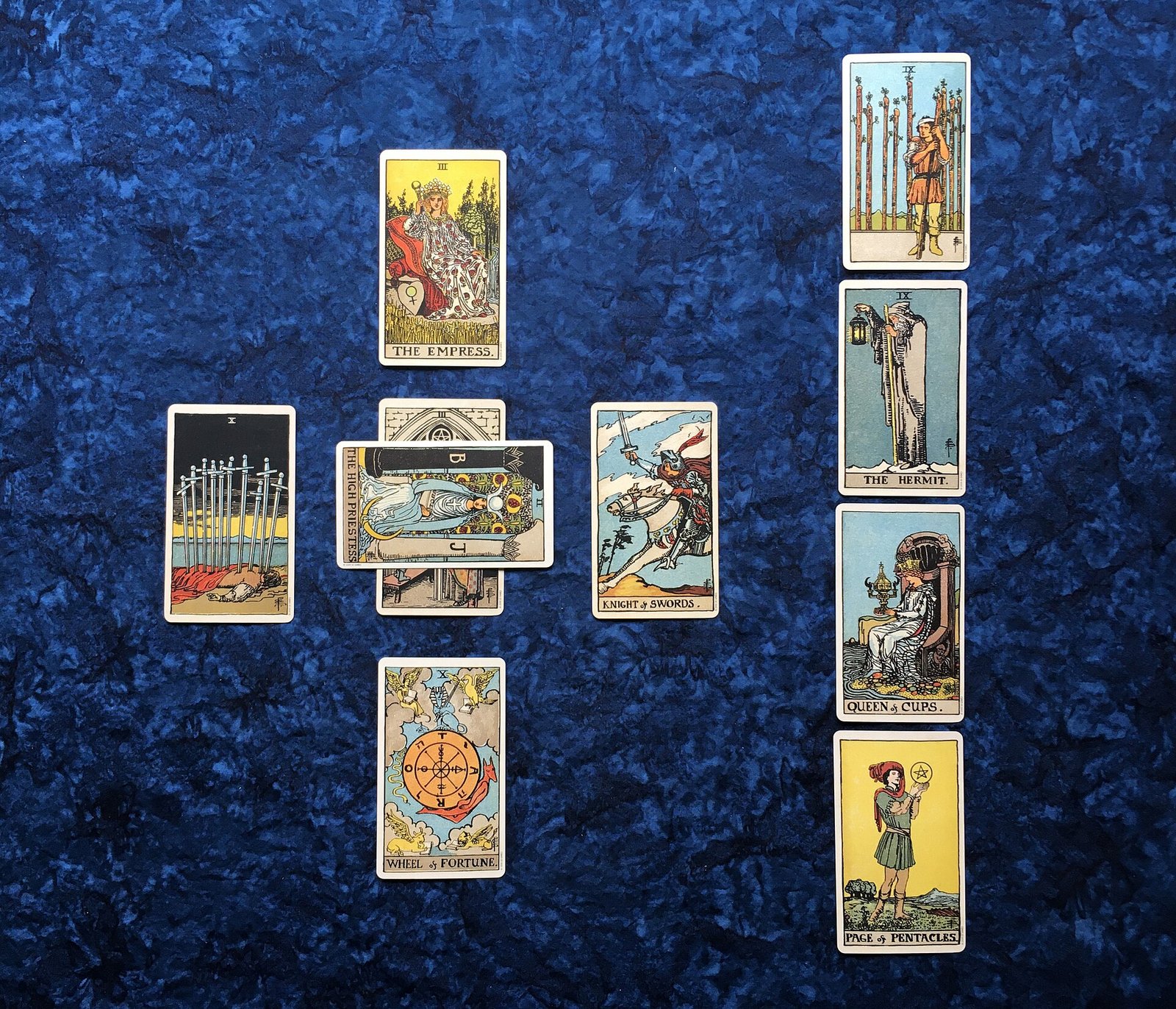 A Celtic cross tarot spread laid out on blue cloth