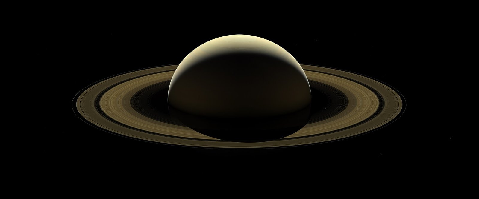 Saturn backlit by the Sun with its rings glowing, in a farewell image from the Cassini mission.