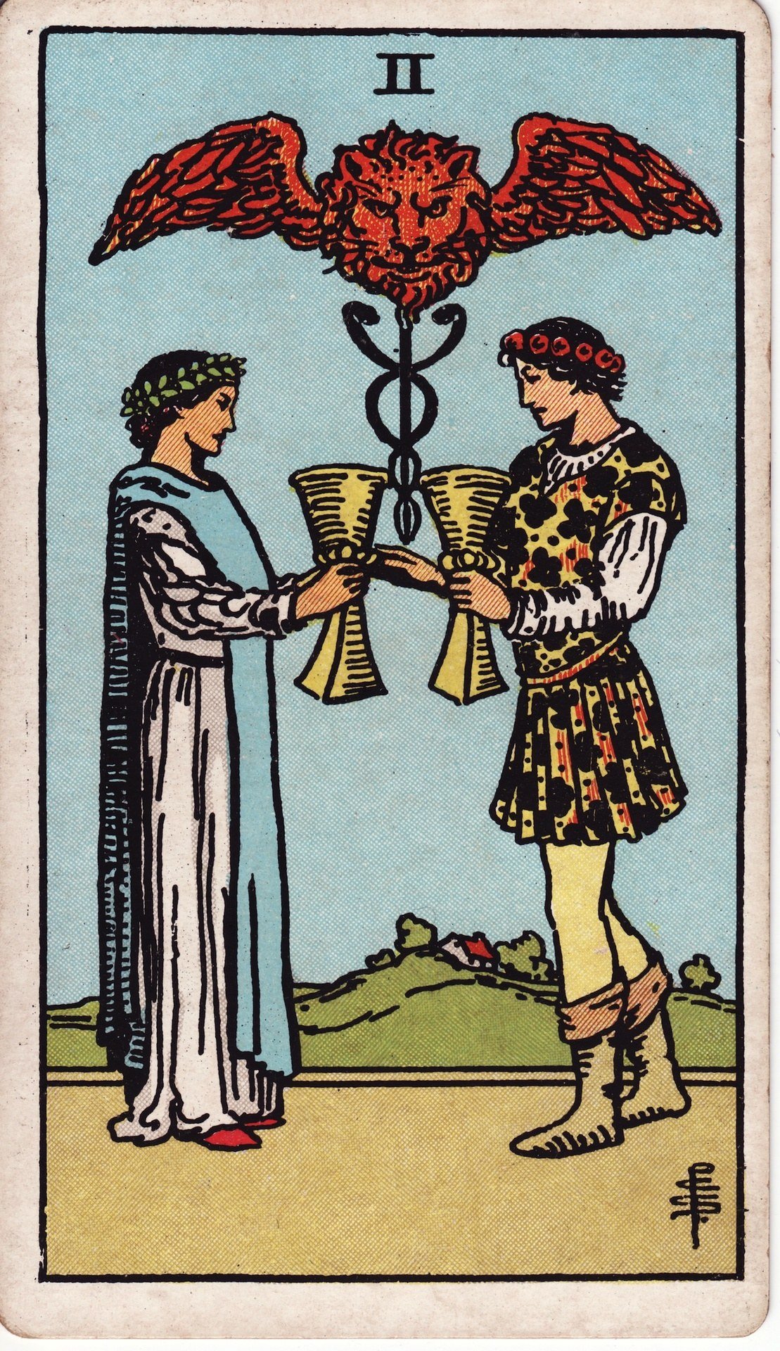 The Two of Cups from the Rider-Waite-Smith tarot deck: a man and a woman face each other in a garden exchanging golden cups, a winged lion head floating above between the cups.