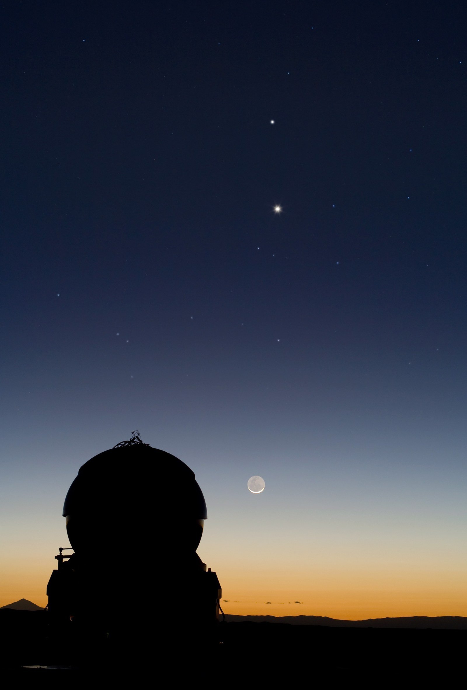 A night sky photograph showing the planets Mercury and Venus aligned with a crescent Moon above an observatory dome