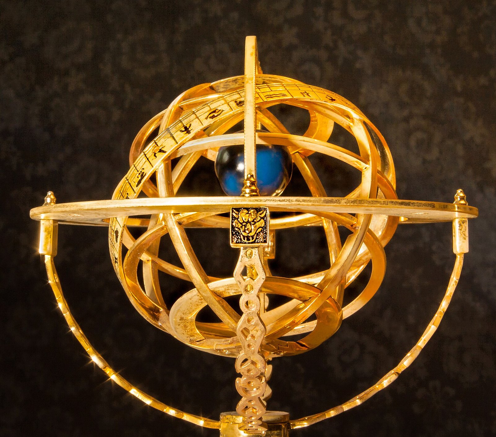 A golden armillary sphere, the astronomical instrument of nested rings used to model the heavens.